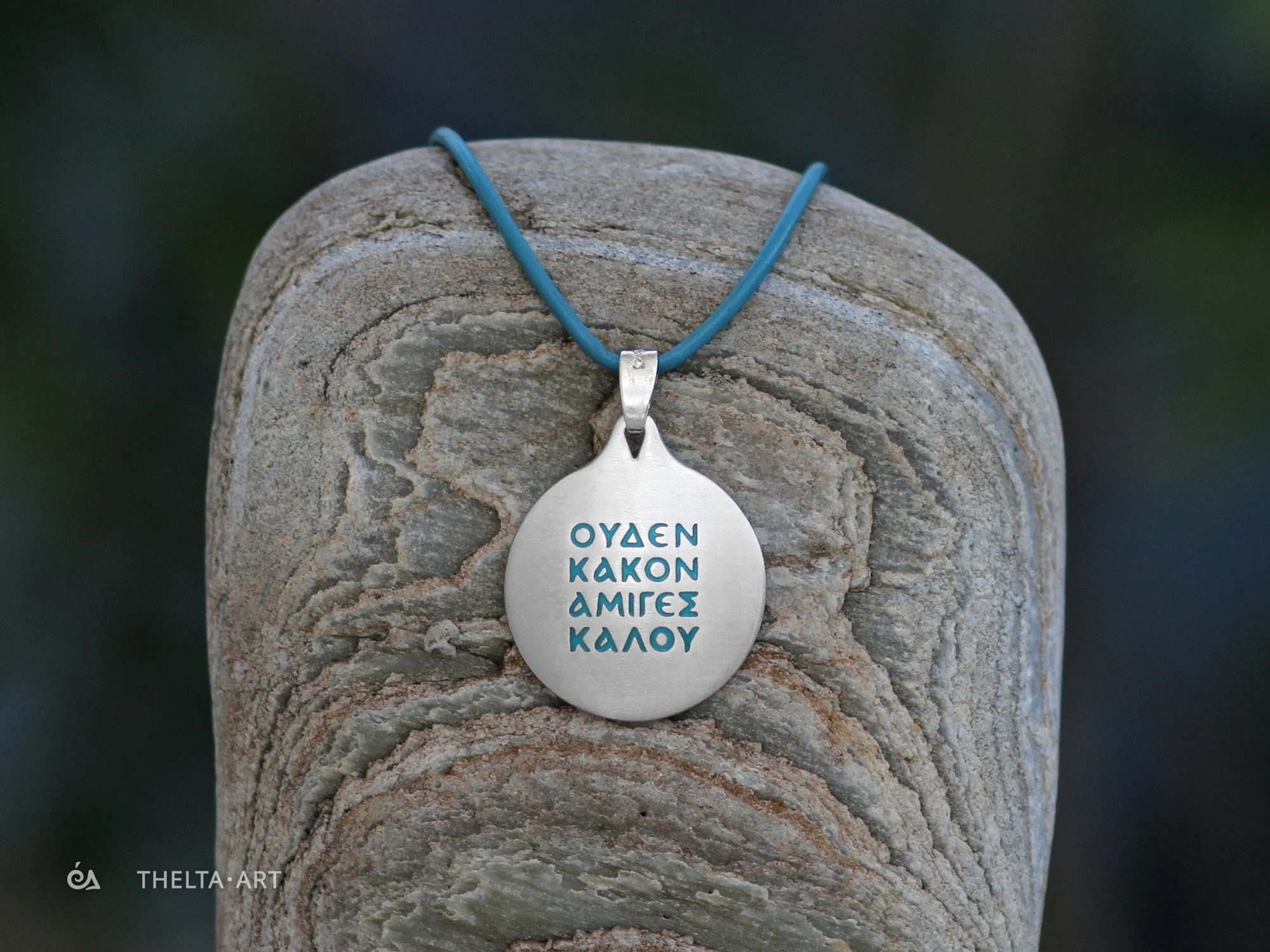 "Uden Kakon Amiges Kalou" Handcrafted sterling silver pendant with turquoise enameled letters & natural leather cord