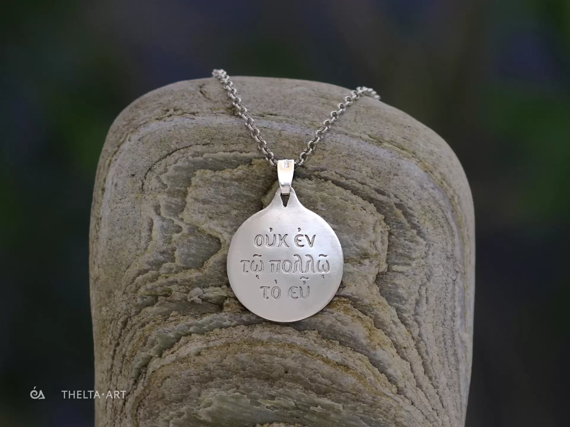 "Uk en to pollo to eu" - a handmade, platinum-plated 925 silver pendant and chain with colorless script.